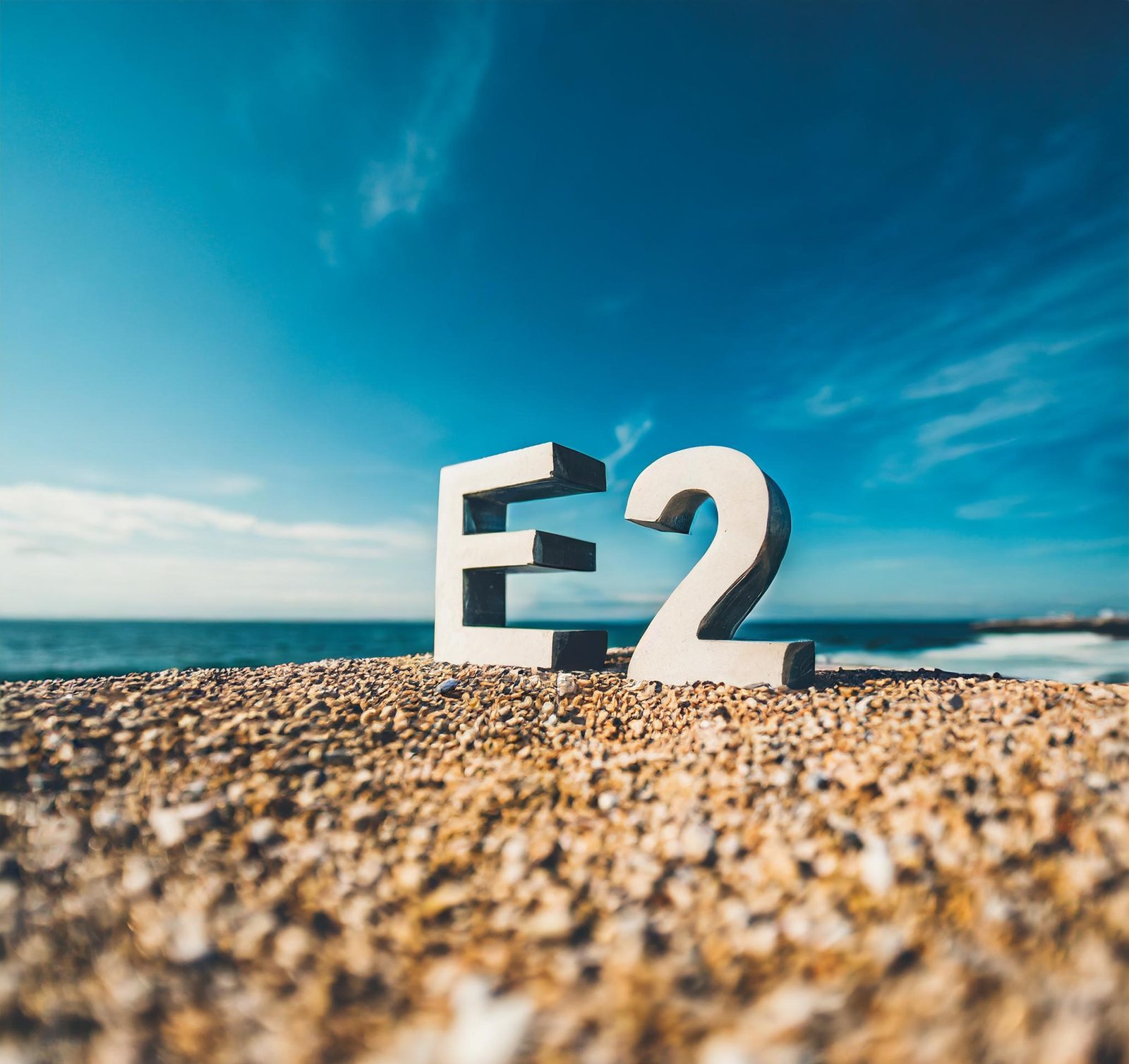 concrete letters "E2" on a beach